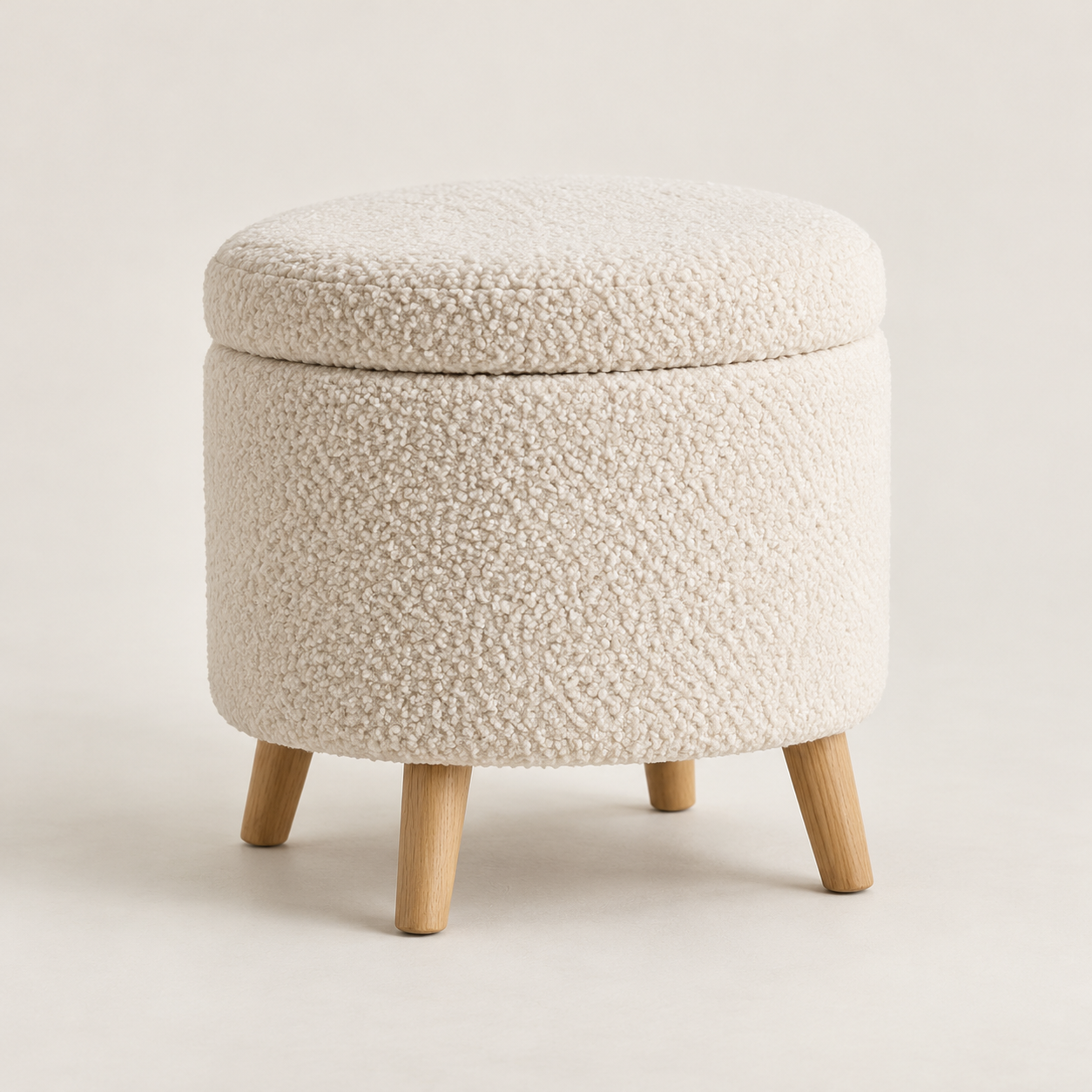 Example of a small ivory boucle storage ottoman with wooden legs